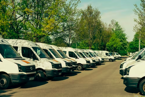 Commercial vehicles lined up in a parking lot